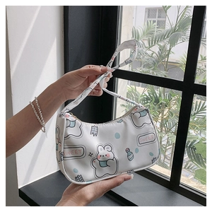 Detailed view of white cartoon rabbit print shoulder bag with sweet text and zip closure