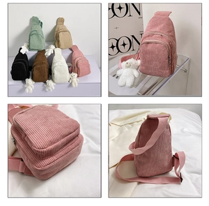 Detail view of corduroy crossbody bag texture and adjustable strap in multiple colors