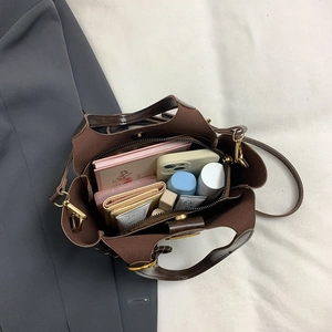Spacious interior of retro brown bucket bag showing compartments and daily essentials