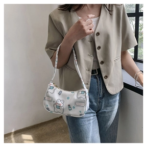 Detail of white PU shoulder bag featuring cute cartoon rabbit prints and sweet text