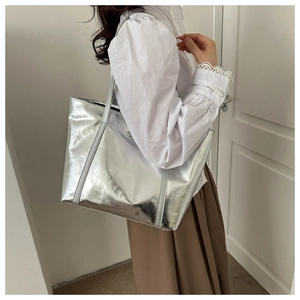 Silver metallic tote bag showing a large capacity design and shiny PU leather finish