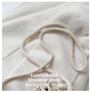 Close-up of a cream woven rope shoulder strap featuring a detailed spiral knit structure