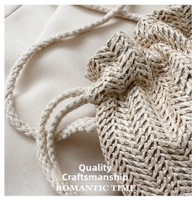 Close-up of premium handcrafted off-white woven texture and sturdy rope strap of the bucket bag
