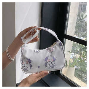 Detail of white cartoon dog print shoulder bag with Luck lettering and top handle