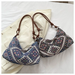 Detail of bohemian jacquard fabric crossbody bags with woven knot strap details