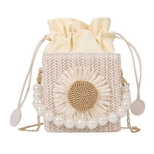 Straw bucket bag with white daisy flower, pearl handle and gold chain strap