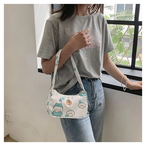 Detail of white cartoon puppy print shoulder bag with zipper and floral canvas pattern