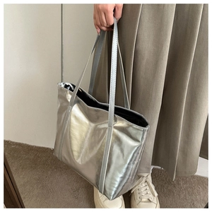 Detail of laser silver tote bag showing metallic texture and large capacity structure