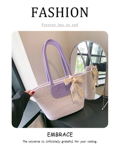 Detailed close-up of purple woven tote bag with elegant cream lace bow and rope handles