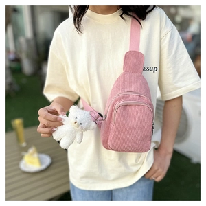 Pink corduroy crossbody fanny pack with dual zippers and a cute plush bear pendant