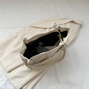 Minimalist beige soft leather tote bag with silver chain handle and large capacity