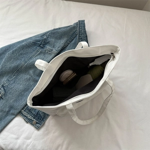 Large white canvas tote bag with zipper and spacious interior for daily essentials
