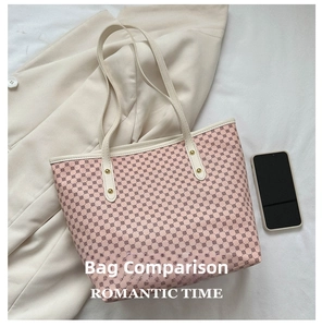 Pink monogram tote bag shown next to a smartphone for a clear size comparison view