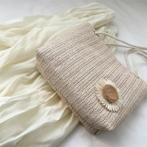 Beige woven straw shoulder bag with crochet flower design in bohemian vacation style