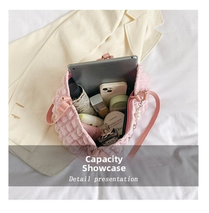 Pink quilted bubble tote bag showing large capacity with daily essentials and pearl charm