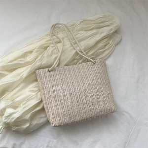 Women's large capacity woven straw tote bag with braided white handles for summer beach