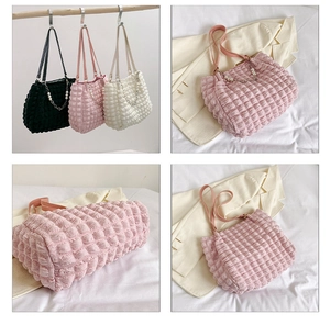 Close-up of pleated bubble texture tote bags with pearl chain and elegant strap