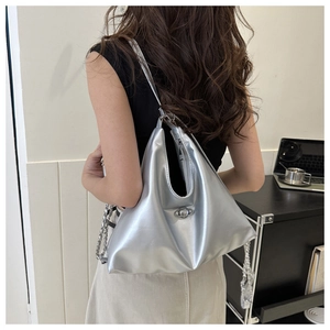 Silver metallic shoulder bag featuring a planet logo emblem and polished chain strap detail
