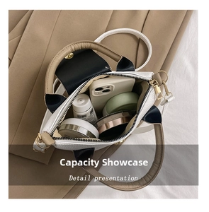 Detail view of the spacious interior of the contrast color bucket bag with daily essentials