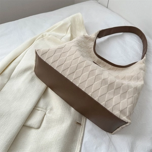 Quilted off-white hobo tote bag with brown leather trim and stylish shoulder strap