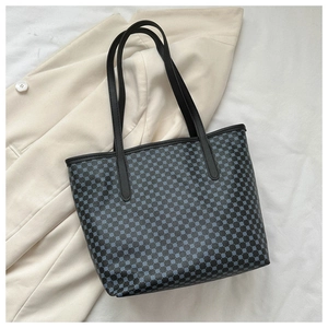 Top view of a geometric pattern tote bag on a beige blazer for urban commuting style