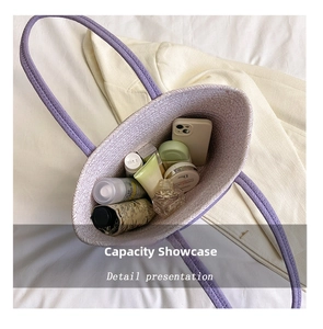 Detail view showing the large capacity of a purple woven tote bag with daily items