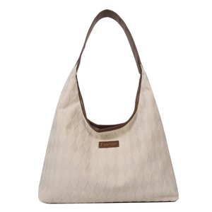 Quilted tote bag in cream fabric with brown leather handles and large capacity