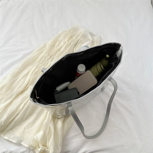 Metallic silver high-capacity tote bag with spacious interior for daily essentials