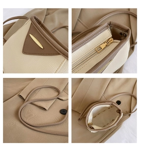 Macro views of two-tone bucket bag featuring litchi grain texture and metal zipper