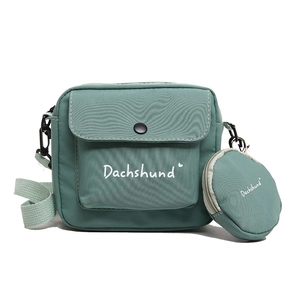Green canvas crossbody bag set with detachable round pouch and wide shoulder strap