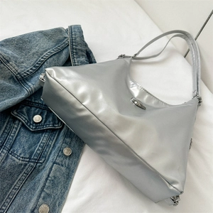 Silver metallic hobo shoulder bag for women with minimalist aesthetic on white fabric