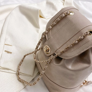 Mini taupe chain backpack with turn-lock closure and classic interwoven strap design