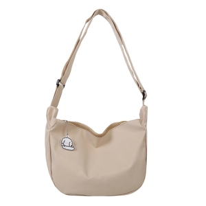 Minimalist beige crescent crossbody bag with cute puppy pendant and adjustable strap