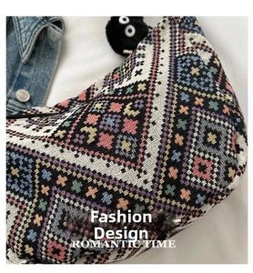 Close-up of ethnic canvas shoulder bag with geometric weave and plush spirit charm
