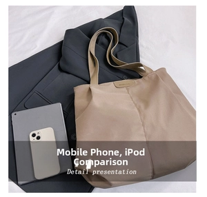 Detail view of khaki nylon tote bag showing interior capacity compared with a tablet