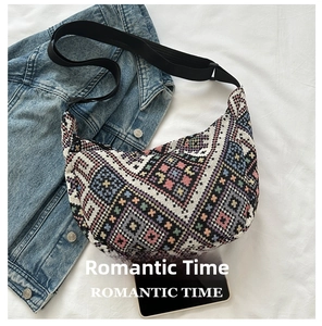 Ethnic bohemian jacquard crescent bag shown next to a smartphone for size scale