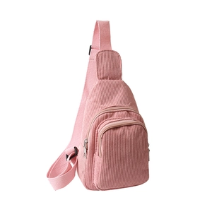 Pink corduroy crossbody fanny pack with adjustable strap on white background