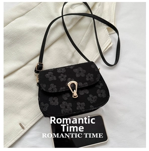 Detail of floral jacquard saddle bag with gold lock and mobile phone size comparison
