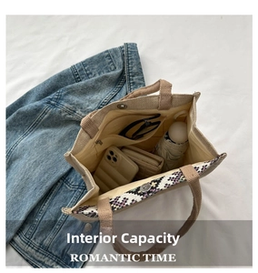 Spacious tote bag interior view showing canvas material and rainbow braided handles