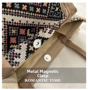 Close-up of ethnic woven tote bag featuring a secure magnetic metal buckle closure