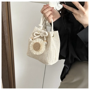 Detailed texture of hand-woven straw bucket bag with sunflower floral decoration