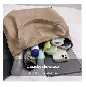 Detail showing the large capacity canvas tote bag filled with a tablet and accessories