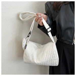 Detail of white pleated shoulder bag with matching round coin purse and wide strap