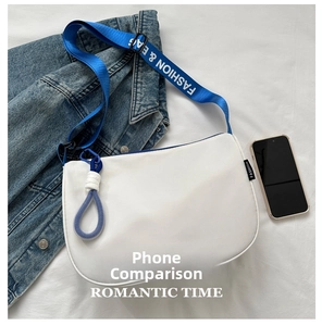 Detailed top view of white crescent bag with blue fashion strap and smartphone size scale