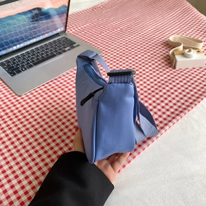 Blue nylon crescent shoulder bag with adjustable strap for women in minimalist style
