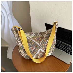 Ethnic geometric woven canvas crossbody bag with vibrant colorful threads and yellow strap