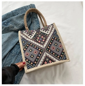 Close-up of geometric woven pattern on a large capacity tote bag with dual handles