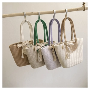 Minimalist woven straw tote bags with lace bows in brown, khaki, purple, and cream colors