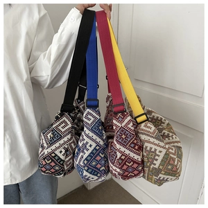 Four colorful ethnic knit crossbody bags with geometric patterns and adjustable straps