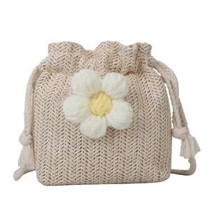 Straw woven bucket bag with floral accent and drawstring closure for women